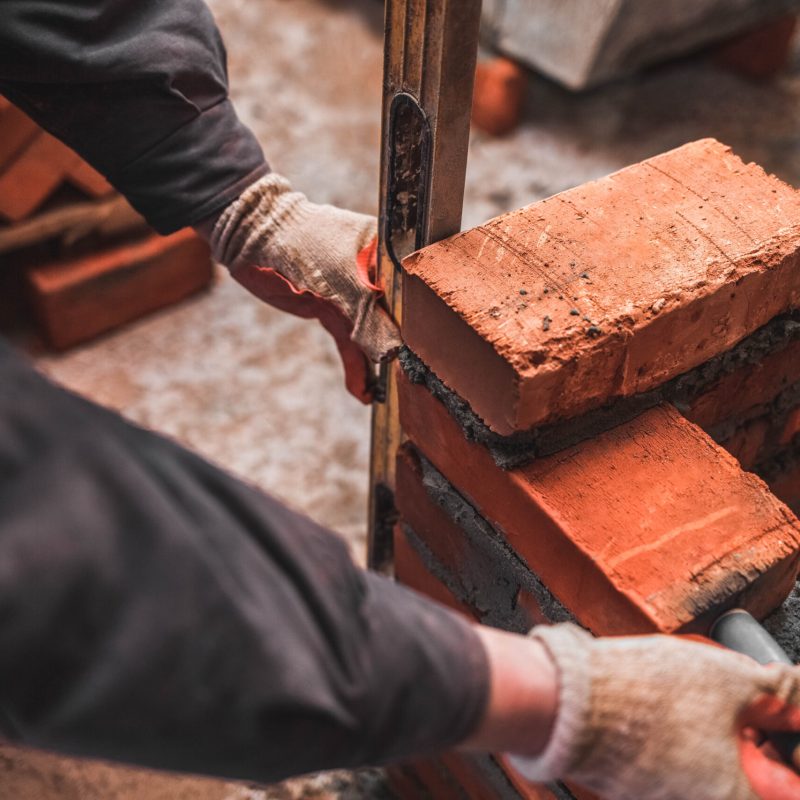 bricklayer puts bricks to make a wall 2022 02 02 05 48 45 utc